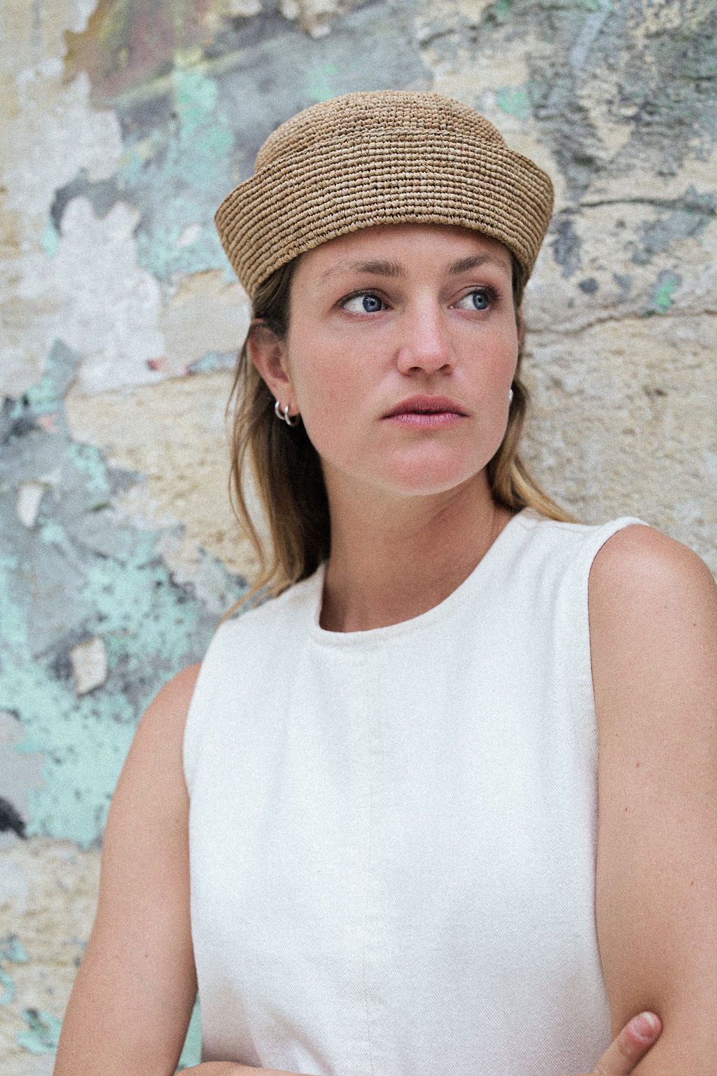 chapeau de marin en raphia marron clair porté sur une robe blanche