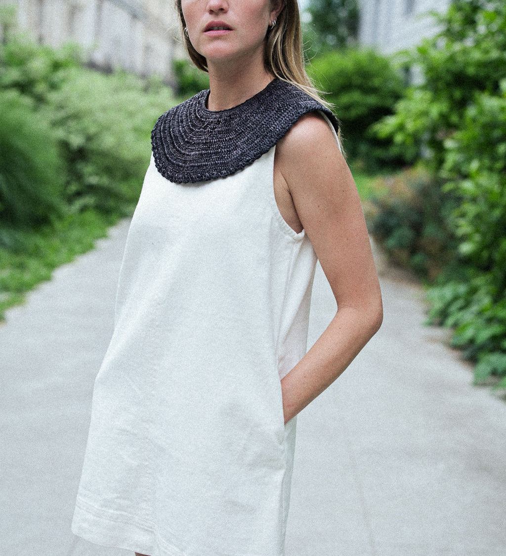 col amovible noir porté en plastron sur une robe blanche 