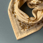 petit foulard en coton imprimé écru noué en pointe