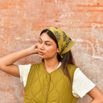 petit foulard en coton imprimé vert olive noué dans les cheveux