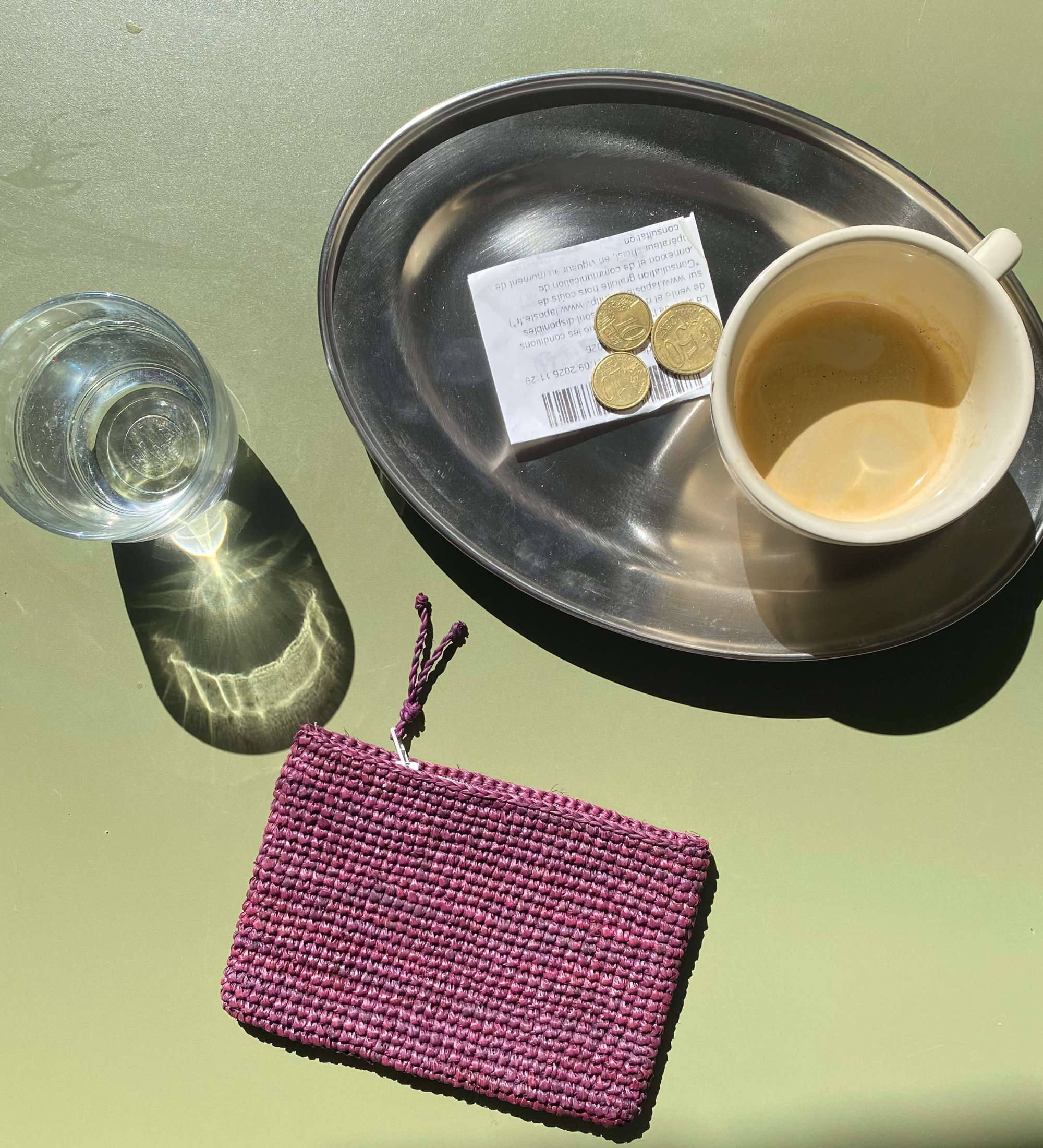 mise en scène du porte carte en raphia bordeaux à la terrasse d'un café